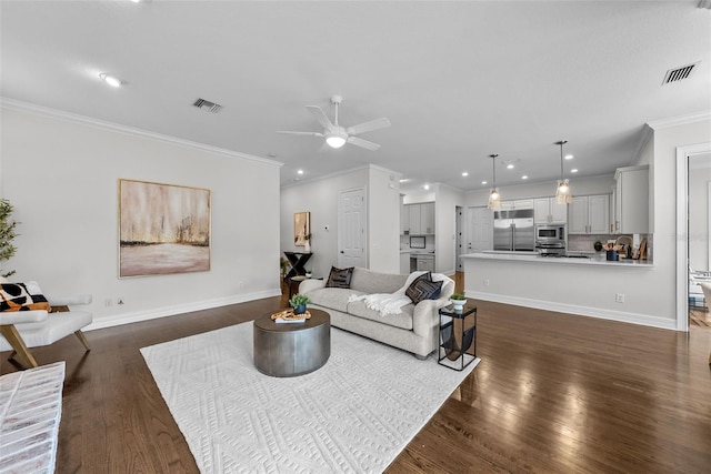 living room featuring ornamental molding, ceiling fan, and dark hardwood / wood-style flooring