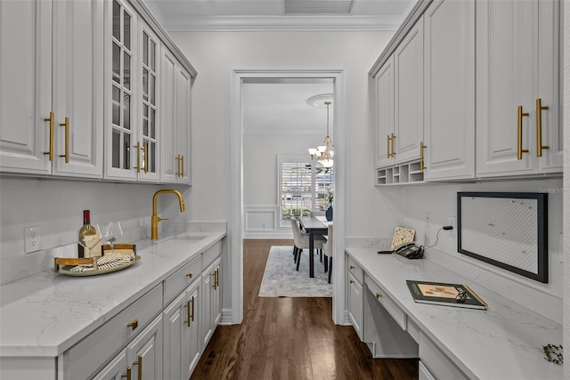 bar with crown molding and light stone counters