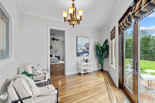 interior space featuring ornamental molding, an inviting chandelier, and light wood-type flooring