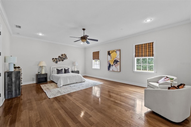 bedroom featuring hardwood / wood-style floors, ornamental molding, and ceiling fan