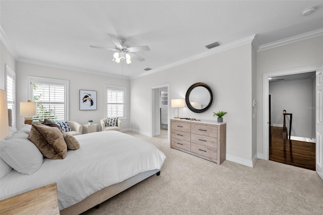 bedroom with crown molding, ceiling fan, and light carpet