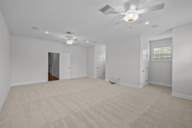 unfurnished room featuring ceiling fan and light carpet