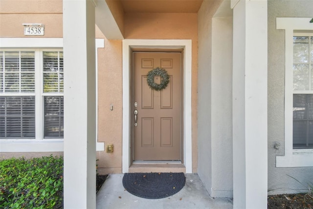 entrance to property with stucco siding