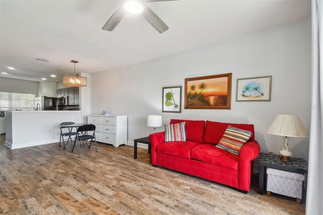 living room with ceiling fan and hardwood / wood-style floors