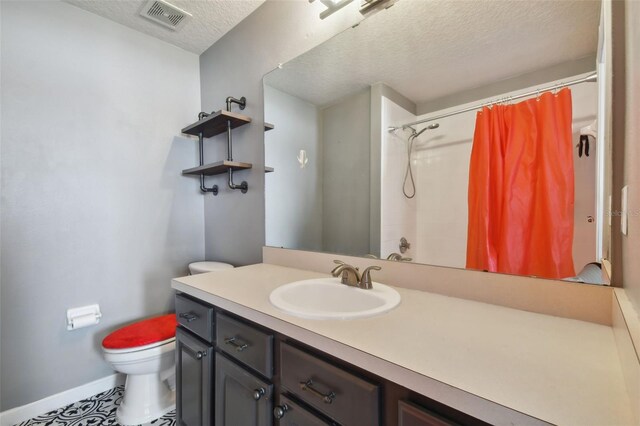 bathroom featuring a textured ceiling, vanity, toilet, and a shower with curtain