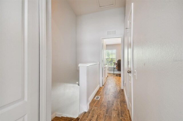 corridor with dark hardwood / wood-style flooring