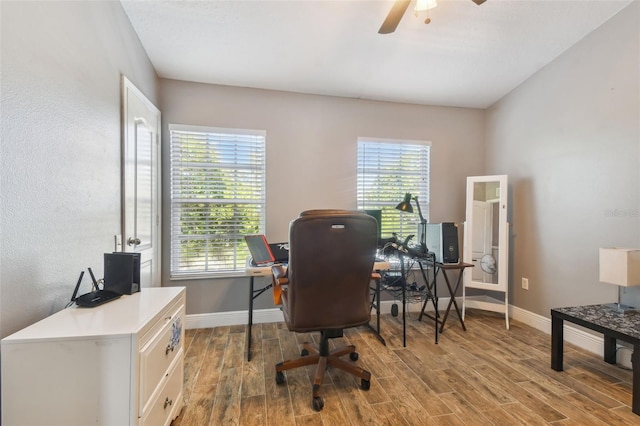 office space with light wood-type flooring, ceiling fan, and plenty of natural light