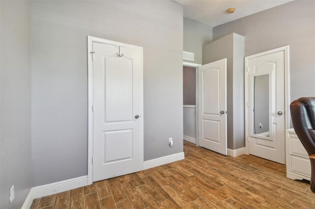 unfurnished bedroom featuring hardwood / wood-style flooring