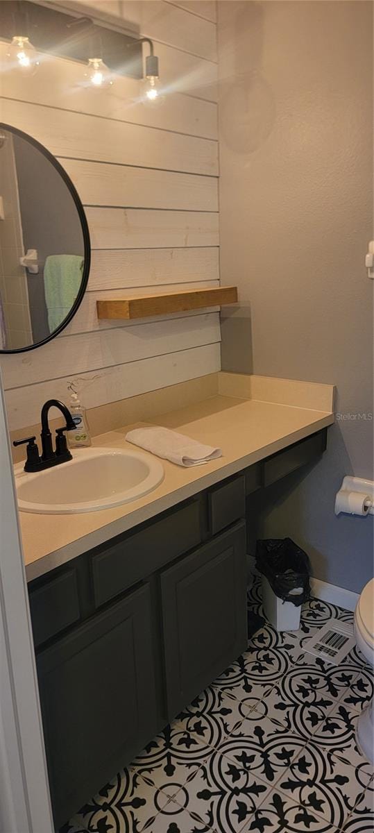 bathroom with vanity, toilet, and tile patterned floors