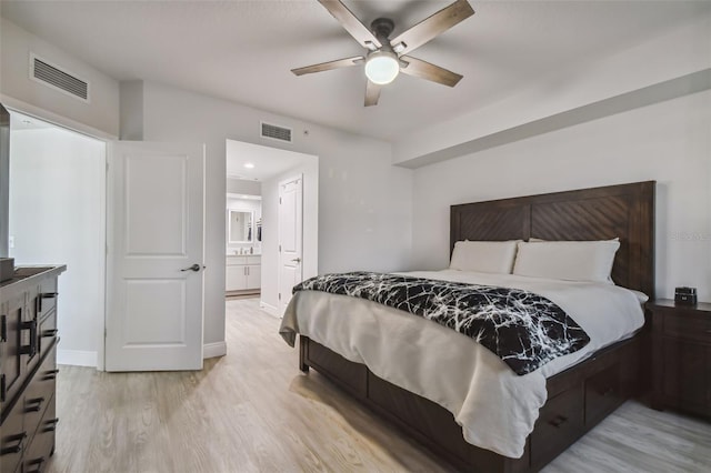 bedroom with ceiling fan, light wood-type flooring, and ensuite bathroom