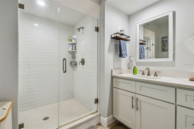 bathroom featuring vanity and an enclosed shower