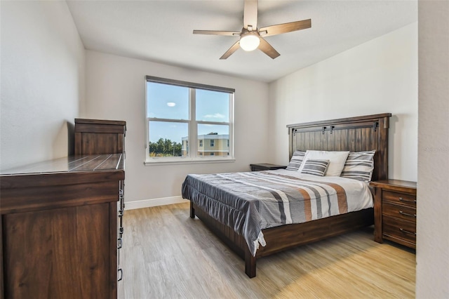 bedroom with ceiling fan and light hardwood / wood-style flooring