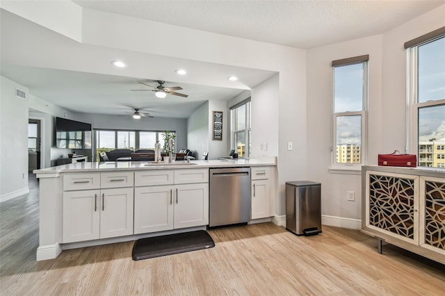 kitchen with white cabinetry, dishwasher, ceiling fan, and light hardwood / wood-style flooring