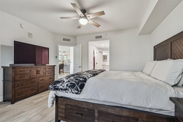 bedroom featuring light wood-type flooring, connected bathroom, and ceiling fan