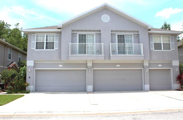 view of front of home featuring a garage and a balcony