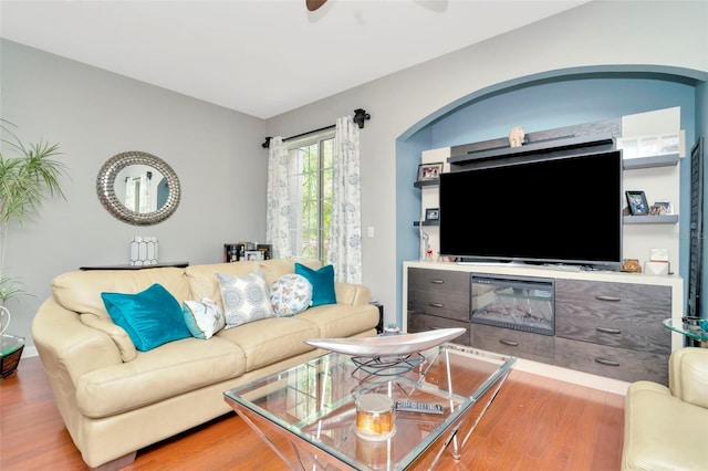 living room with wood-type flooring and ceiling fan