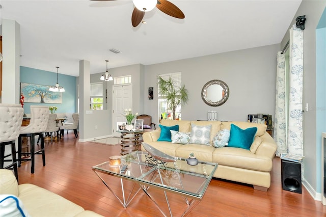 living room with hardwood / wood-style floors and ceiling fan