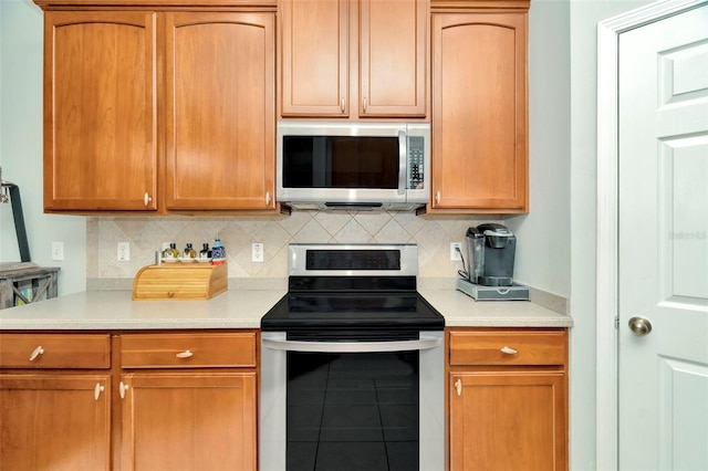 kitchen with backsplash and stainless steel appliances