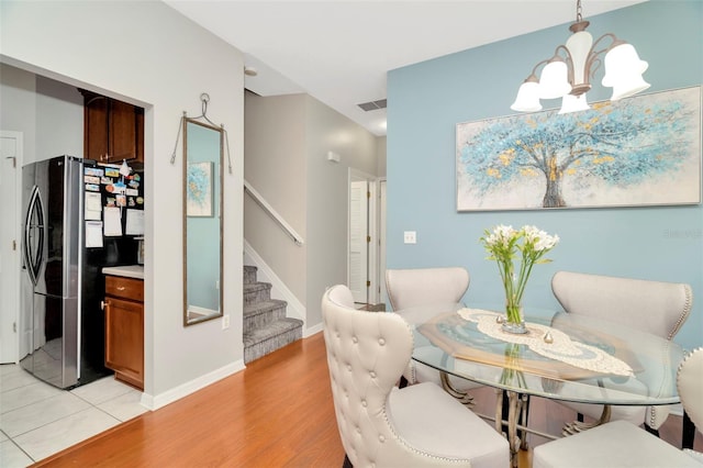 living area featuring a chandelier and light hardwood / wood-style floors