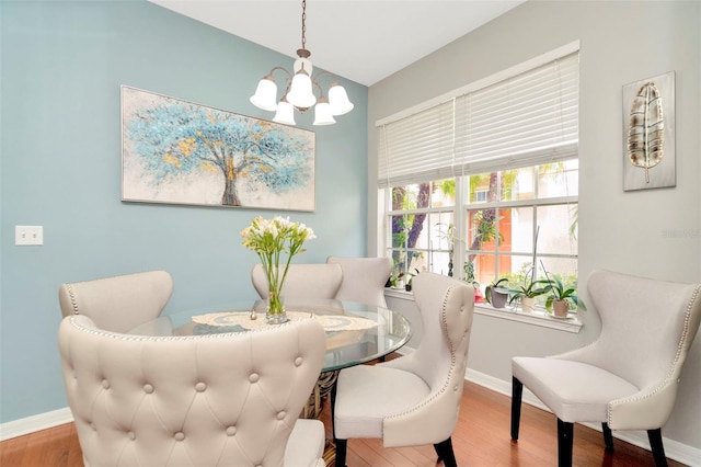 sitting room with wood-type flooring and a chandelier