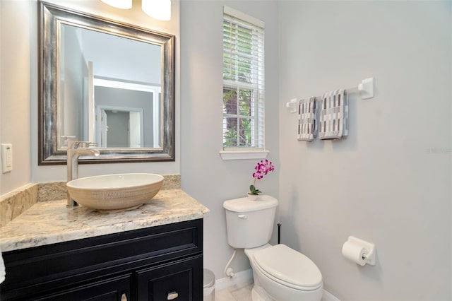 bathroom featuring toilet and vanity