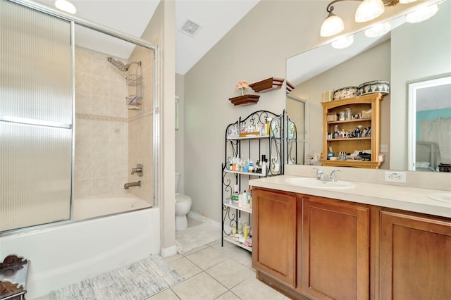 full bathroom featuring tile patterned flooring, vaulted ceiling, toilet, and vanity