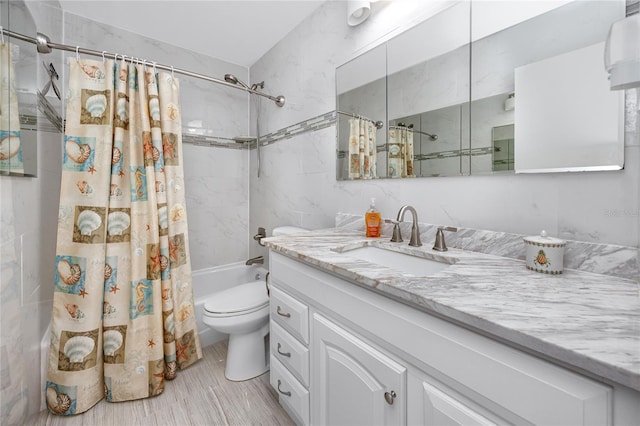 full bathroom featuring shower / tub combo with curtain, vanity, and toilet