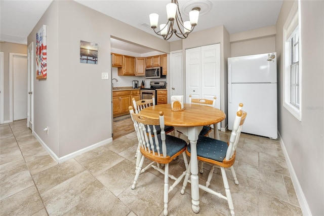 dining room with a notable chandelier and sink