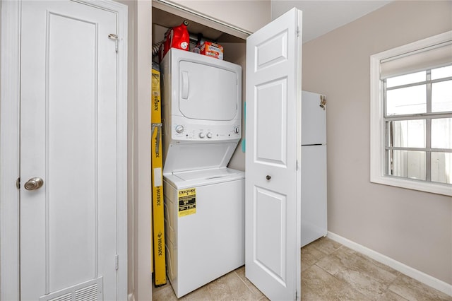 laundry room featuring stacked washer and dryer