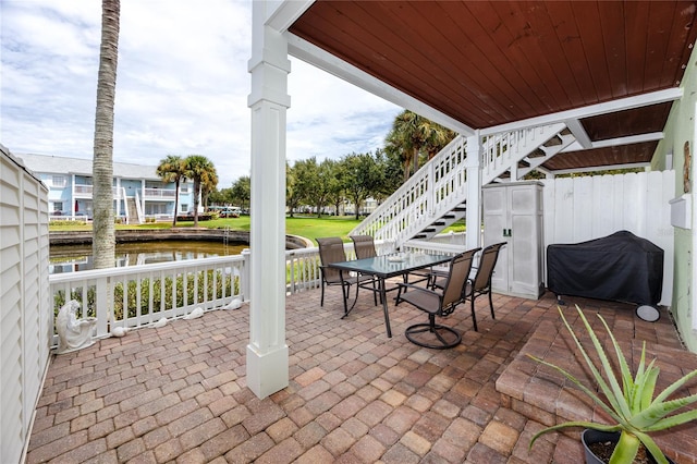 view of patio featuring a grill and a water view