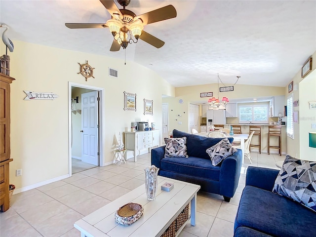 tiled living room featuring ceiling fan, a textured ceiling, and vaulted ceiling