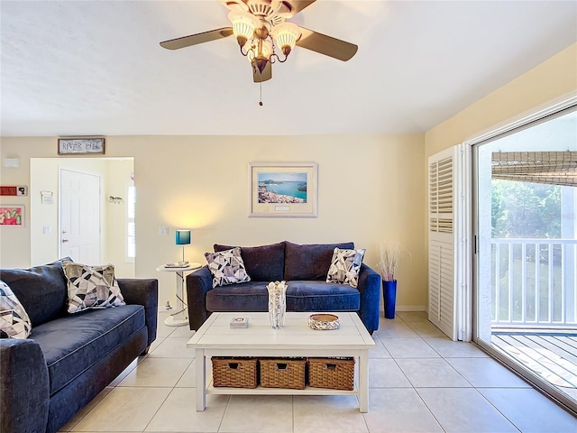 tiled living room with plenty of natural light and ceiling fan