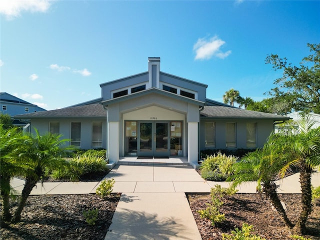 rear view of house featuring french doors