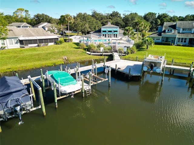 dock area featuring a lawn and a water view