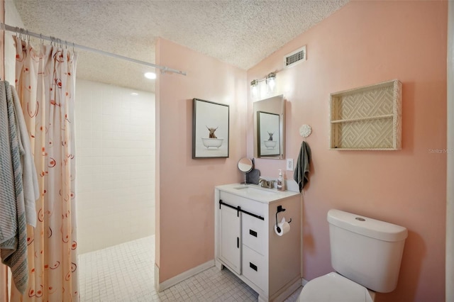 bathroom with vanity, curtained shower, toilet, and a textured ceiling