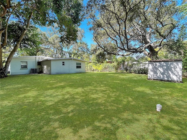 view of yard featuring a storage unit and cooling unit