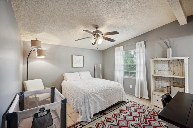 tiled bedroom with ceiling fan, lofted ceiling with beams, and a textured ceiling