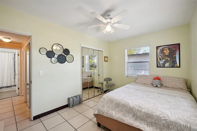 bedroom featuring ceiling fan, light tile patterned flooring, and a closet