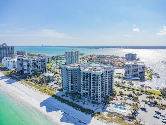 drone / aerial view featuring a water view and a beach view