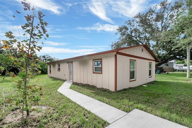 view of side of property with a yard