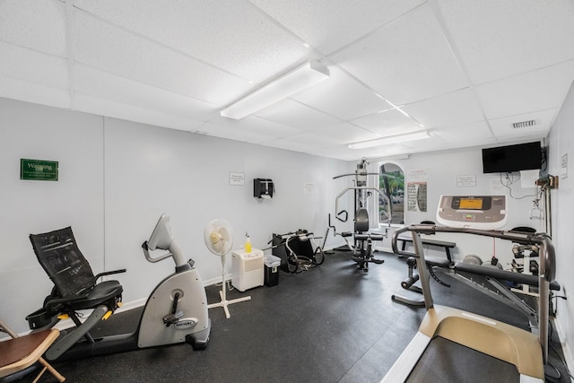 exercise room featuring a paneled ceiling