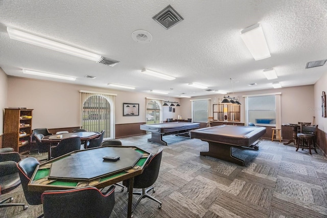 playroom with pool table, carpet, and a textured ceiling