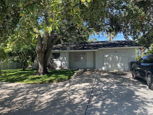 ranch-style home featuring a garage and a front lawn