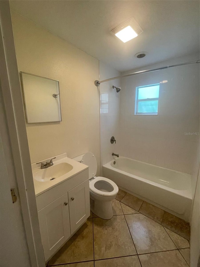 full bathroom with tiled shower / bath combo, vanity, toilet, and tile patterned floors