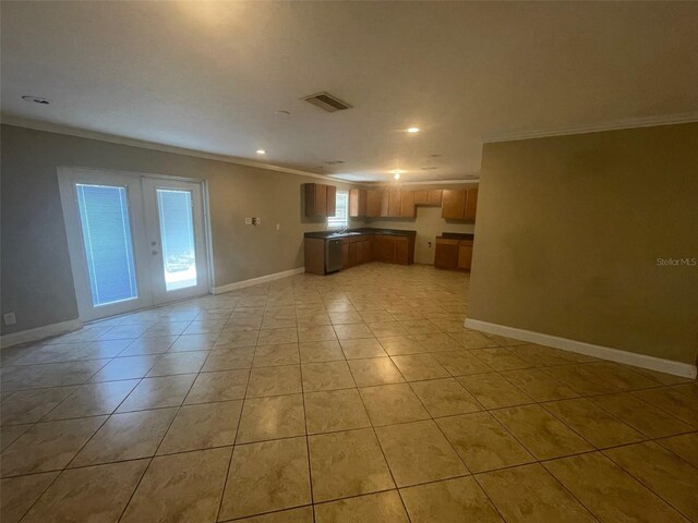 unfurnished living room with crown molding, french doors, and light tile patterned flooring