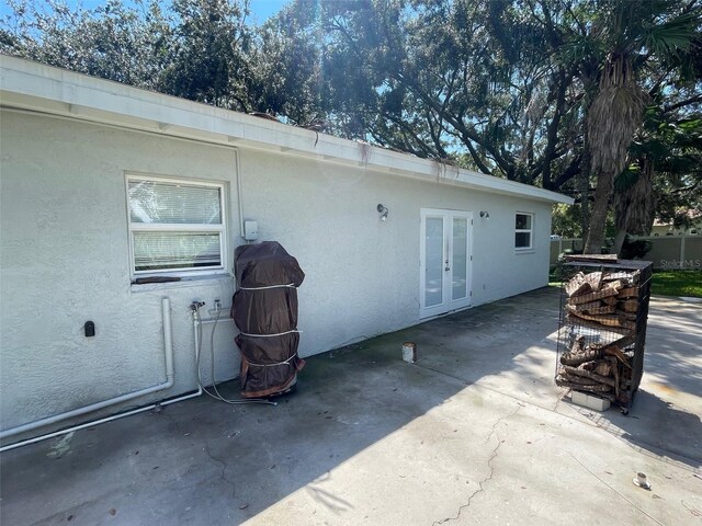 view of side of property featuring a patio and french doors