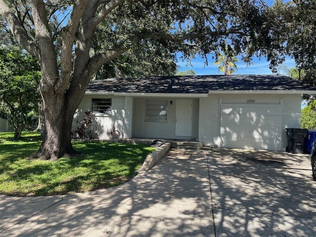 single story home featuring a garage and a front lawn