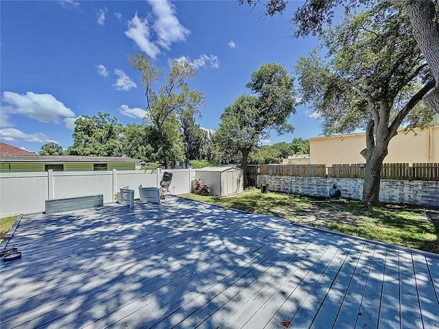 4477 67th St N, Saint Petersburg, FL 33709 - deck with a fenced backyard, an outdoor structure, and a storage shed