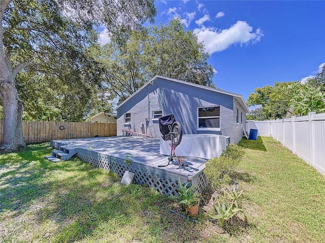 4477 67th St N, Saint Petersburg, FL 33709 - rear view of house with a lawn, a fenced backyard, and a wooden deck