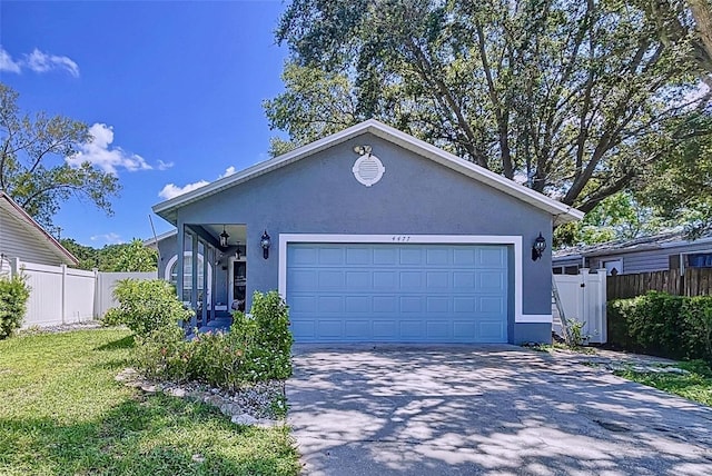 view of front of house featuring a garage and a front lawn